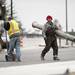 A construction worker walks with heavy materials on the East Stadium bridge on Tuesday. Daniel Brenner I AnnArbor.com